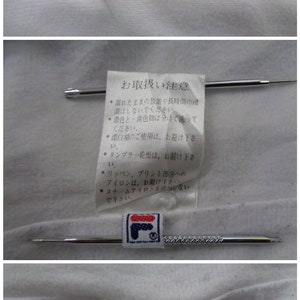 May include: Close-up of a white garment with a navy blue collar. The FILA logo is visible on a tag. Additional tags with Japanese text and care instructions are also present.