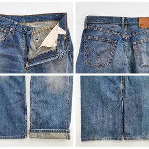 May include: Close-up shots of blue denim jeans. The jeans are faded and worn, with a button and zipper closure. The back pockets and a red tag are visible. The bottom of the jeans are cuffed. The jeans are a classic style.