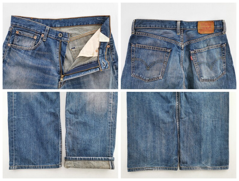 May include: Close-up shots of blue denim jeans. The jeans are faded and worn, with a button and zipper closure. The back pockets and a red tag are visible. The bottom of the jeans are cuffed. The jeans are a classic style.