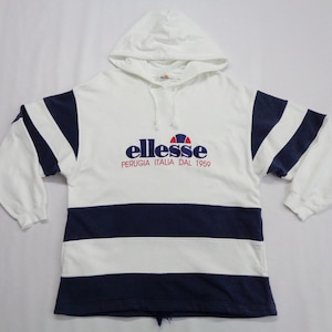 May include: White hooded sweatshirt with navy blue stripes and accents. The sweatshirt features the brand name "ellesse" in navy blue and red, with "PERUGIA ITALIA DAL 1959" printed below. The sleeves have navy blue stripes.