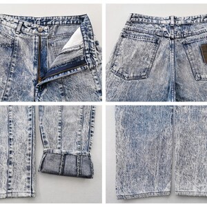 May include: Acid wash denim jeans with a button and zipper closure. The jeans have a high waist, front and back pockets, and a brown patch on the back. The denim has a faded, marbled appearance.