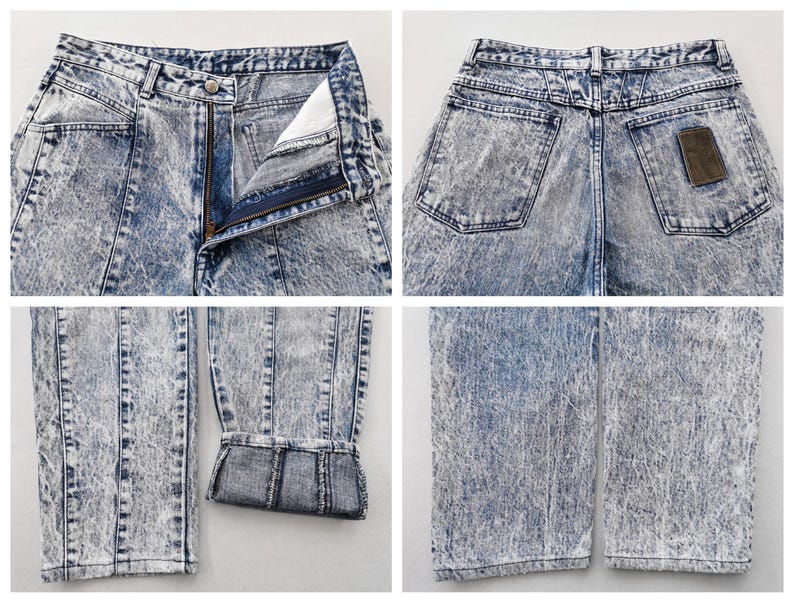 May include: Acid wash denim jeans with a button and zipper closure. The jeans have a high waist, front and back pockets, and a brown patch on the back. The denim has a faded, marbled appearance.