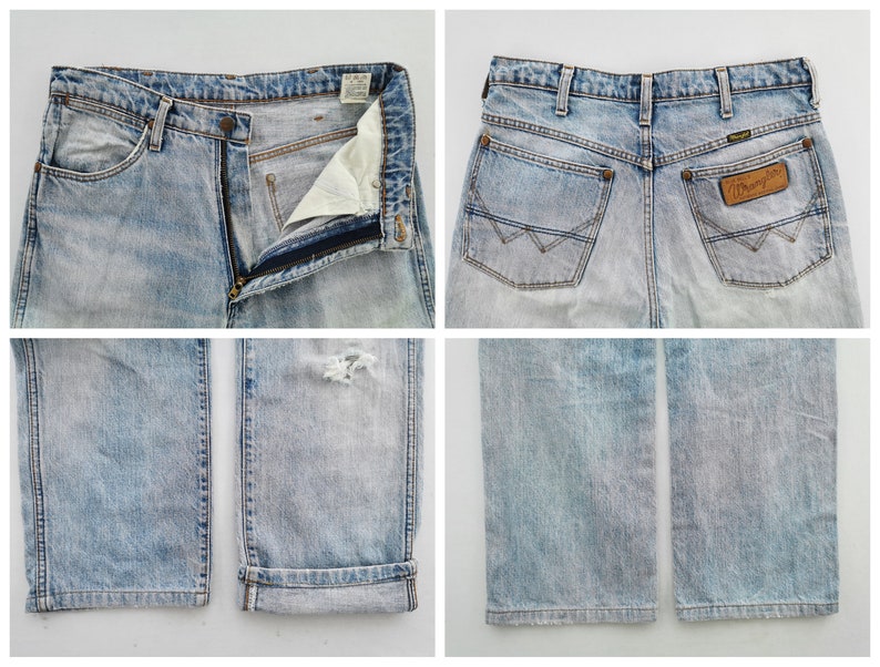 May include: Light blue denim Wrangler jeans. The jeans have a faded wash, a zipper fly, and a distressed area on the right leg. The back features two pockets and a Wrangler patch.