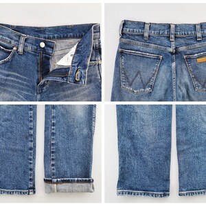 May include: Four-panel image of blue denim jeans. The first panel shows the front with the button and zipper open. The second panel shows the back with the Wrangler logo. The third panel shows the folded hem. The fourth panel shows the unfolded hem.