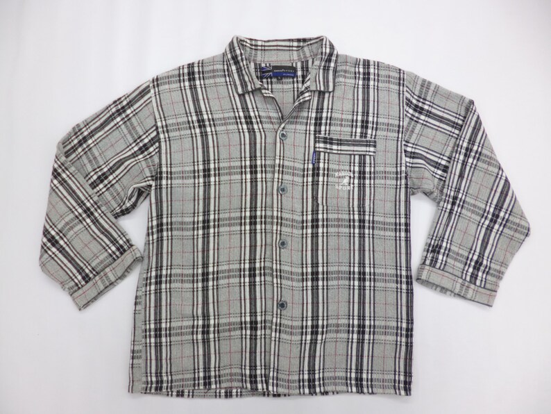 May include: A set of three ceramic mugs with a speckled, matte finish. The mugs are in shades of blue, green, and white. Each mug has a rounded handle. The mugs are stacked on top of each other.