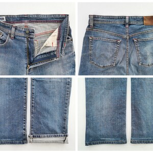 May include: Four-panel image of blue denim jeans. The jeans have a button and zip closure, front and back pockets, and a brown leather patch. The cuffs are rolled up on one leg. The denim has a faded wash.
