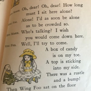 May include: A children's book illustration featuring two dolls, Miss Marie and Wing Foo. Miss Marie is wearing a yellow hat and a white dress. Wing Foo is wearing a green and brown outfit. The text reads: "Miss Marie and Wing Foo. Oh, dear! Oh, dear! How long must I sit here alone? Alone! I'd as soon be alone as to be crowded so. Who's talking? I wish you would come down here. Well, I'll try to come. A box of candy is on my toe. A top is sticking into my side. There was a rustle and a bump! Then Wing Foo sat on the floor by Miss Marie."
