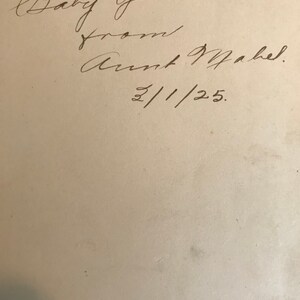 May include: Handwritten inscription on a white page that reads "To Baby Gene. From Aunt Mabel. 2/1/25."