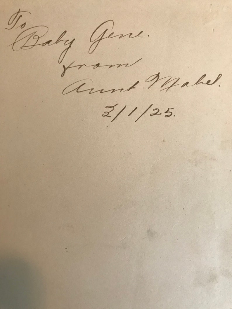 May include: Handwritten inscription on a white page that reads "To Baby Gene. From Aunt Mabel. 2/1/25."