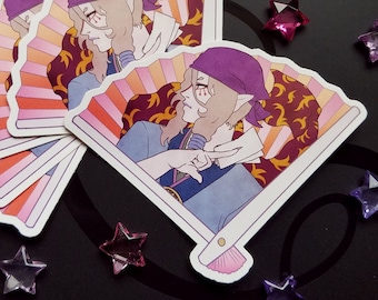 May include: A stack of fan-shaped stickers featuring an anime-style character with elf-like ears, wearing a purple headscarf and blue clothing. The fan design has a striped pattern in shades of pink, orange, and yellow, with a burgundy background.