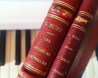 Operas by Georges Bizet. 2 volumes. Complete scores of L'Arlésienne and Les Pêcheurs de perles (piano and voice). Ca.1920s. Leather binding