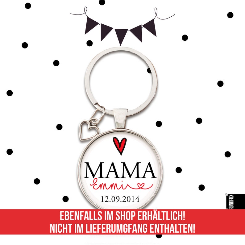 May include: A silver key chain with a heart charm and a round glass charm. The glass charm has a white background with black text that says "MAMA Emmive" and a red heart. The date "12.09.2014" is printed below the text.
