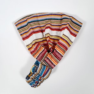 May include: A colorful striped headband with a white background. The headband is made of a soft, stretchy fabric and is perfect for adding a pop of color to any outfit.