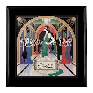 May include: A black framed art print featuring an Art Deco illustration of a glamorous party scene. The central figure, in a green dress, stands prominently. The print includes the name "Charlotte" in a decorative banner, with other figures in evening wear.