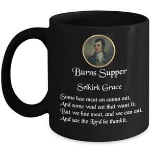 May include: Black coffee mug with a white image of Robert Burns and a quote from his poem "Selkirk Grace". The quote reads: "Some hae meat an canna eat, And some wad eat that want it: But we hae meat, and we can eat, And sae the Lord be thankit."