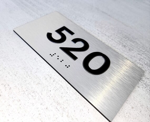 ADA room number signs. Custom ADA compliant number plaques. Apartment numbers with Braille. Tactile hotel room numbers.