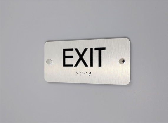 ADA compliant Exit sign with Grade 2 Braille and Tactile text. ADA Exit signs.