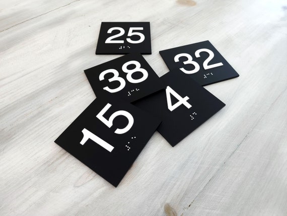 Square ADA compliant room number signs. Custom ADA number plaques. Raised number signs with Braille. Tactile Grade 2 Braille door numbers.