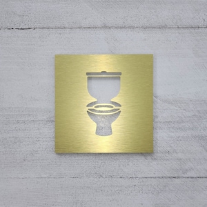 Toilet symbol sign. Square bathroom sign. Restroom signs with toilet symbol. Gold. Silver. White. Black.