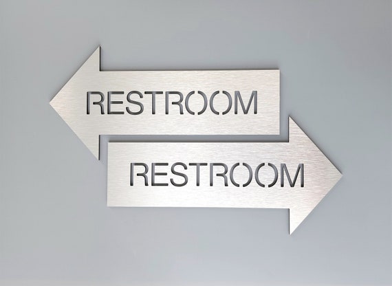 Restroom sign with arrow. Bathroom signs. Wayfinding sign. Information sign. Direction sign. Arrow signs.