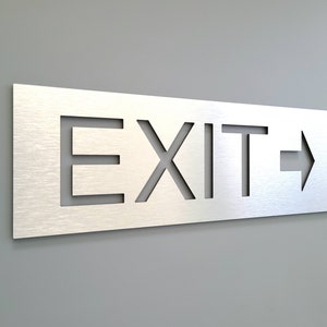 Exit sign with arrow. Emergency exit sign. Arrow signs. Directional exit signs. Safety signage for business.