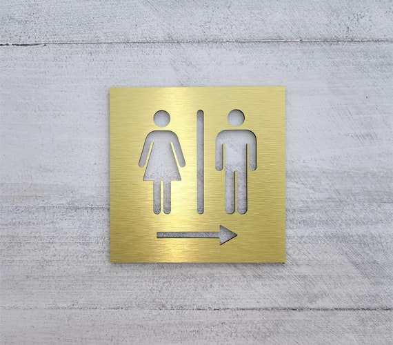 Restroom arrow sign. Bathroom signs with arrow. Directional restroom signs. Informational business sign. Gold. Silver. Black. White.