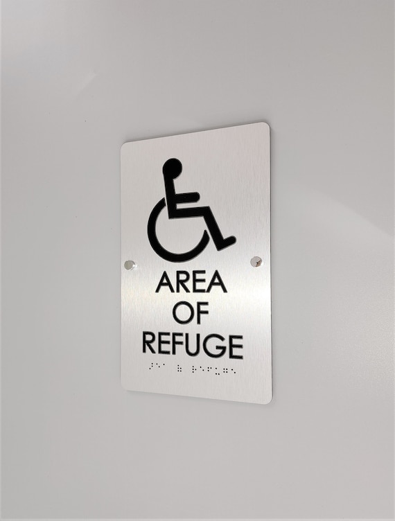 Area of refuge ADA compliant sign. Fire emergency signs. Safety signage. ADA building signs. ADA Braille sign with tactile symbol and text.