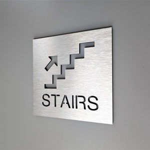Stairs signs with arrows. Directional stairs sign. Stairway signage. Stairwell exit. Warning and caution signs. Safety signs.