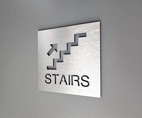 Stairs signs with arrows. Directional stairs sign. Stairway signage. Stairwell exit. Warning and caution signs. Safety signs.