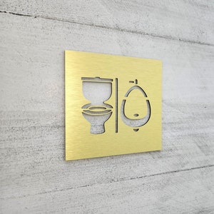 Bathroom sign with toilet and urinal symbols. All gender restroom signs. Unisex toilet sign. Gender neutral restroom door signs. Złoto