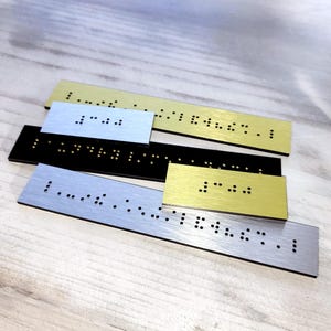 Custom Braille plaques. Braille signs with custom text. Grade 2 domed Braille. Grade 1 Braille labels. Braille strips for existing signs.