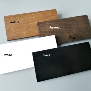 May include: Four wood samples in different colors: walnut, espresso, white, and black. The samples are arranged in a staggered pattern.