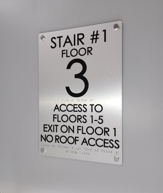 Stairwell floor number signs. ADA and IFC compliant stairwell signs. Floor level number signs with tactile text and Grade 2 Braille.