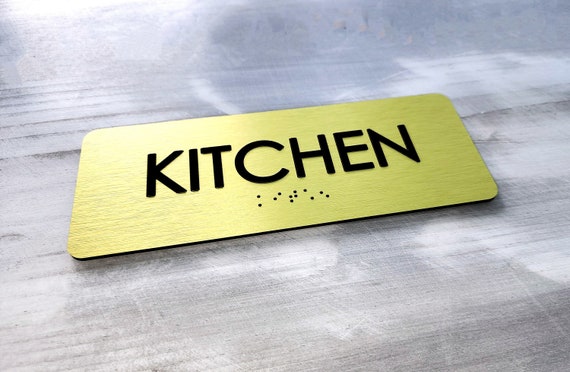 Kitchen door sign. Kitchen signs. ADA compliant room identification signs. Custom ADA door signs. Tactile text. Grade 2 Braille sign.