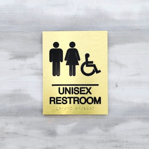 ADA compliant unisex restroom sign. Handicap accessible unisex bathroom. Wheelchair accessible restroom. ADA bathroom signs with Braille.