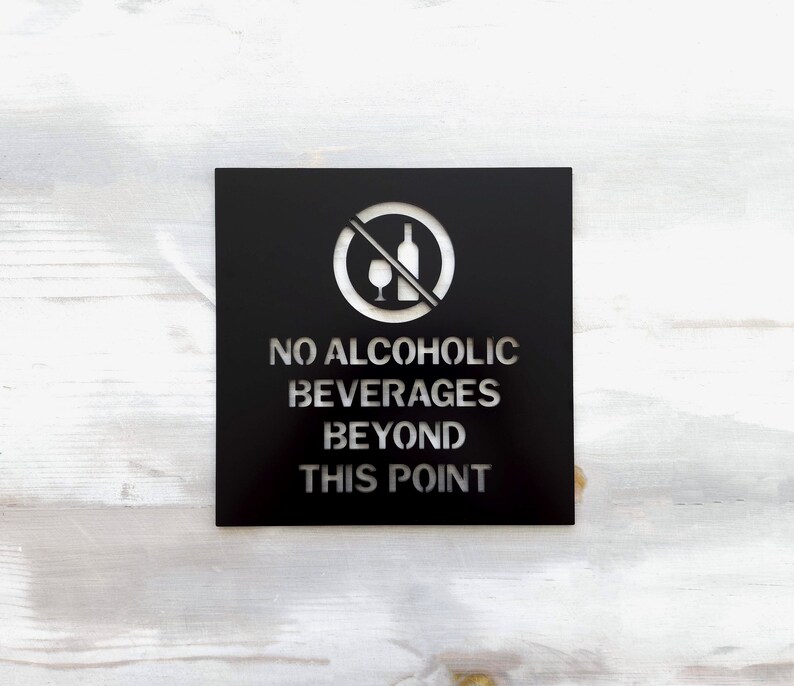 May include: Black metal sign with a white silhouette of a wine bottle and glass with a diagonal line through it. The sign reads "No Alcoholic Beverages Beyond This Point."