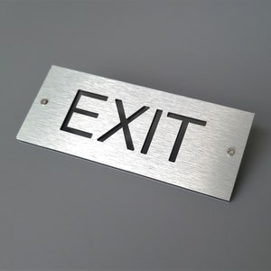 Aluminum exit sign. Metal exit door sign. Safety business sign.