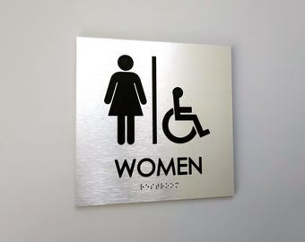Accessible women restroom sign. Handicap accessible women's bathroom. ADA compliant bathroom signs. Tactile Braille signs.