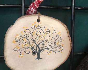 Hand painted and stamped stylized tree ornament on a maple tree slice.