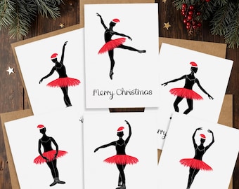 May include: Christmas cards featuring black silhouettes of ballerinas in red tutus and Santa hats. Each card has the text "Merry Christmas" in a simple font. The cards are arranged on a wooden surface with festive decorations.