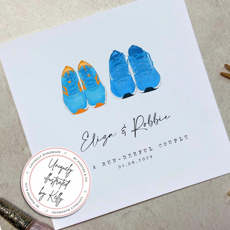 May include: A white card with a blue and orange illustration of two running shoes. The card has the text "Eliza & Robbie" and "A RUN-DERFUL COUPLE 01.08.2024". A pink circle with the text "Uniquely illustrated by Kelly" is in the bottom left corner.