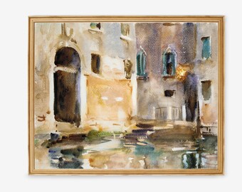 May include: Watercolor painting of a European building with an arched doorway and windows, reflected in the water. The artwork is framed in a gold-colored wooden frame. The color palette includes shades of brown, beige, and blue.