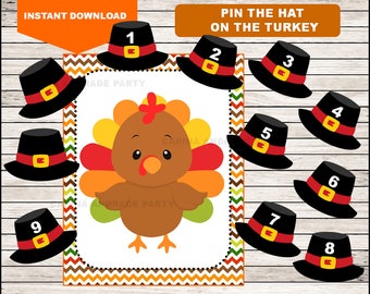 May include: A Pin the Hat on the Turkey game featuring a central illustration of a brown turkey with colorful feathers, surrounded by nine individual black pilgrim hats, each marked with a white number from one to nine and a red and yellow band.
