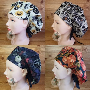 May include: Four Halloween-themed scrub caps. One cap features pumpkins and owls on a white background. Another has a black background with pentagrams and moons. A third has a dark floral and skeleton design. The last has orange pumpkins.