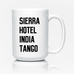 May include: White ceramic mug with black text that reads "SIERRA HOTEL INDIA TANGO".