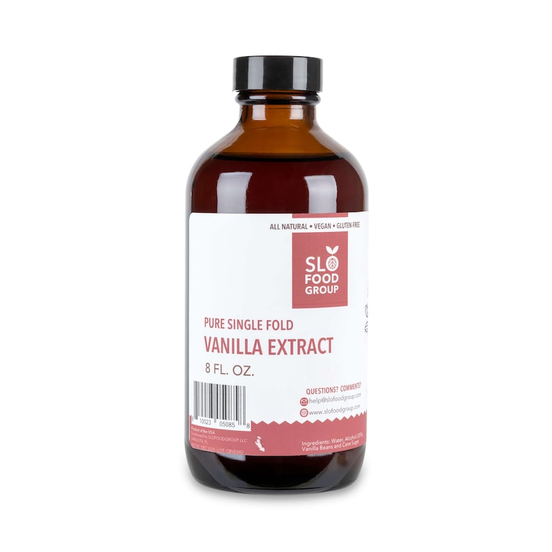 May include: A brown glass bottle with a black cap containing 8 fluid ounces of pure single fold vanilla extract. The bottle label is white with black text and a red logo for SLO Food Group. The label also includes the text "All Natural, Vegan, Gluten Free".