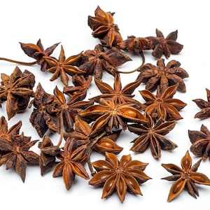 May include: A collection of dried star anise pods, a popular spice used in Asian cuisine. The pods are brown and have a star shape with eight points.