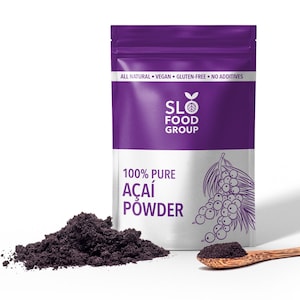 May include: A purple pouch with the text "SLO FOOD GROUP" and "100% PURE AÇAÍ POWDER". A scoop of dark purple powder is next to the pouch, and a wooden spoon with a small amount of powder is in front of the pouch.