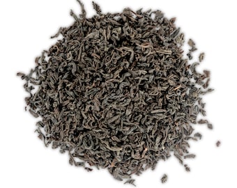 May include: A close-up of a pile of loose leaf black tea. The tea leaves are dark brown and have a slightly curled shape.