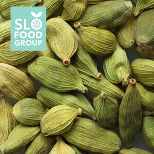May include: A close-up image of green cardamom pods. The pods are arranged in a pile, showing their natural color and texture.
